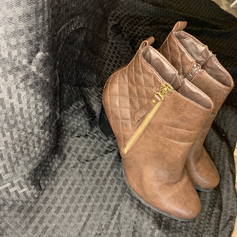 Brown heels with a gold excess zipper